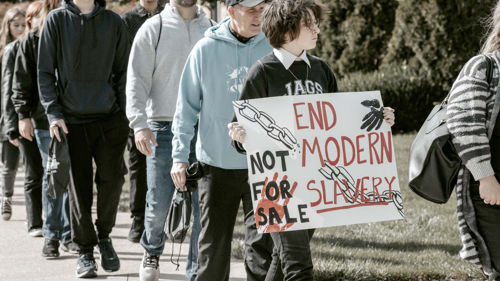Participants carrying an “End Modern Slavery” sign during a human trafficking awareness walk.
